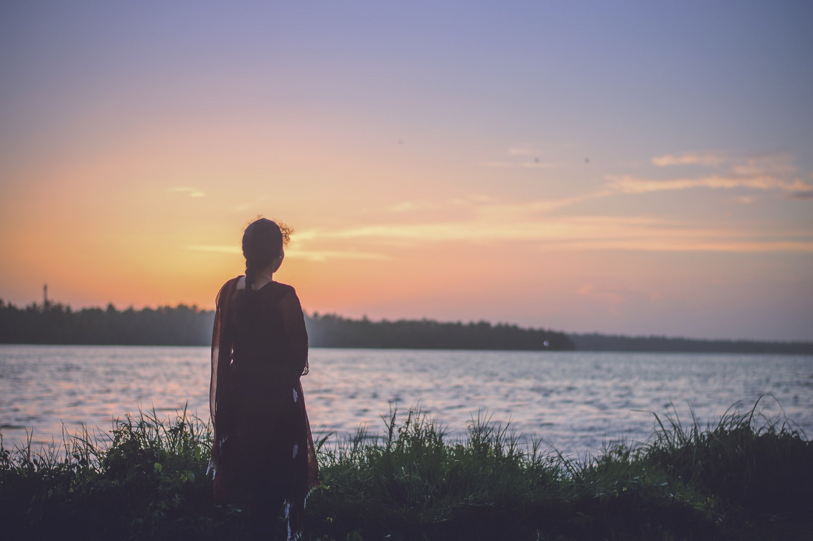 lonely woman watching sunset